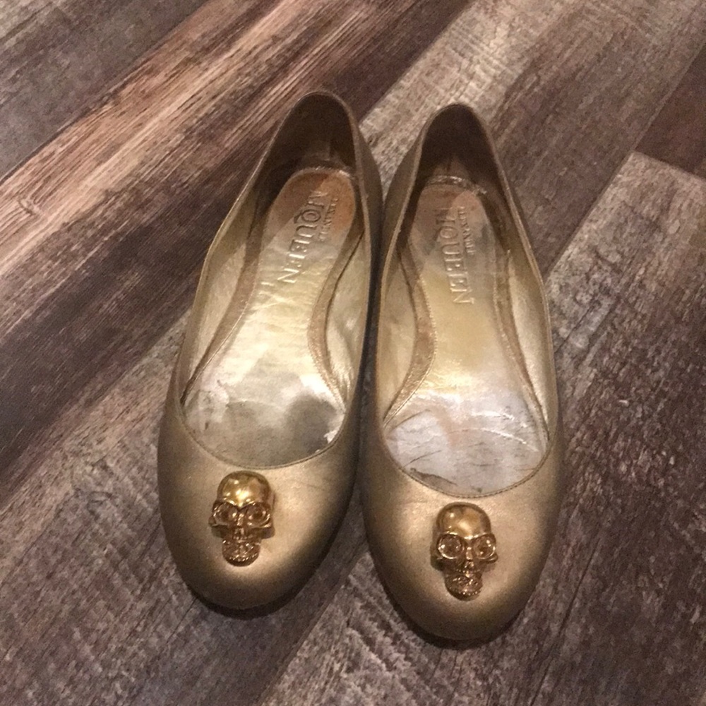 Alexander McQueen gold leather ballet flats.
